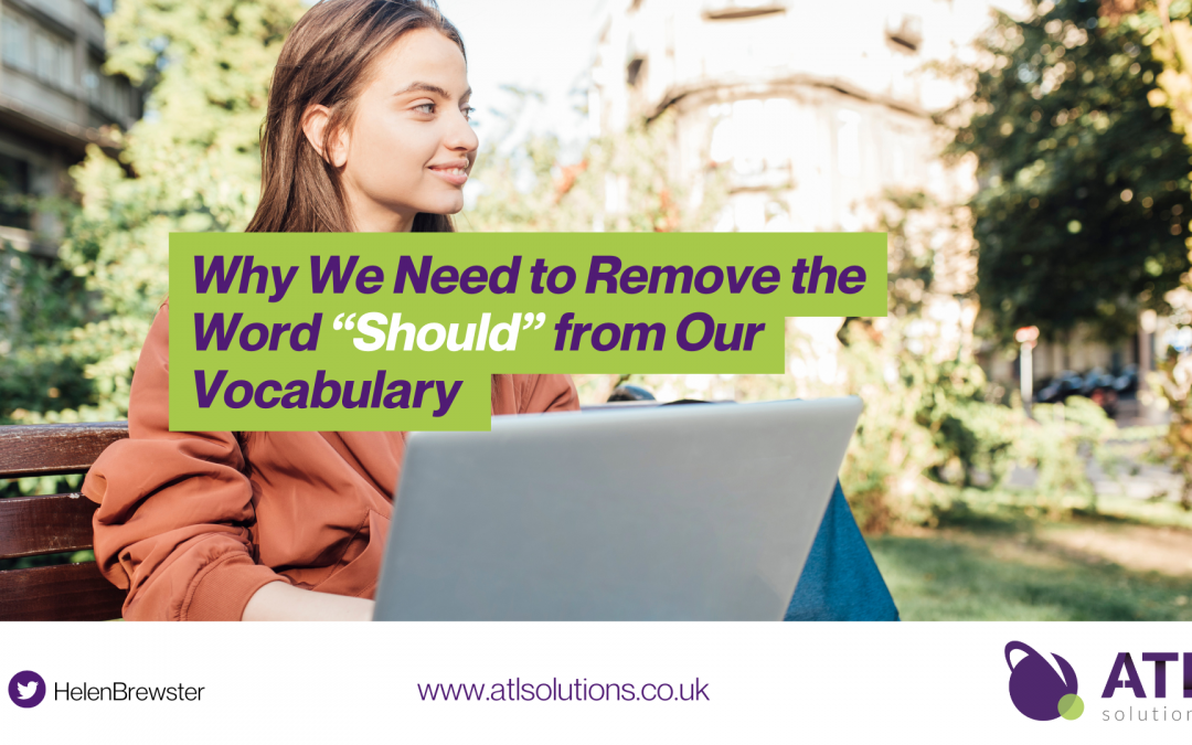 Article Title: Why We Need to Remove the Word “Should” from Our Vocabulary , Image in the background of a young woman sitting in the garden with her laptop, smiling.